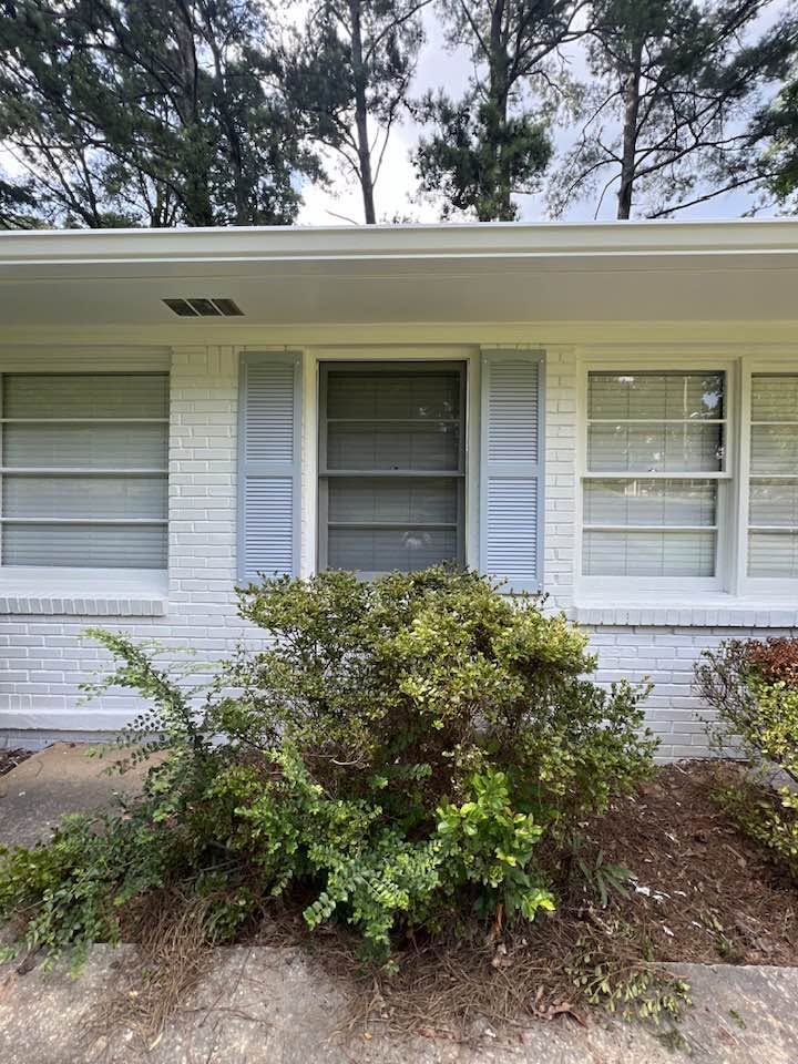 Exterior painting, painted brick house