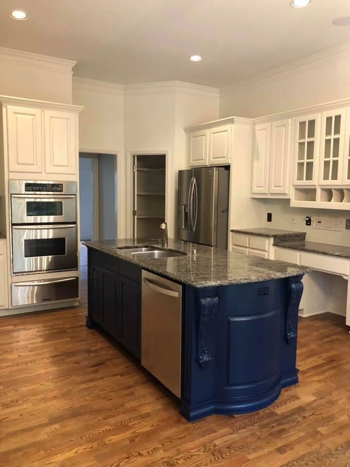 Navy blue kitchen island with stone countertop